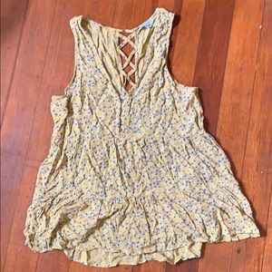 Yellow tank top with blue flowers on it